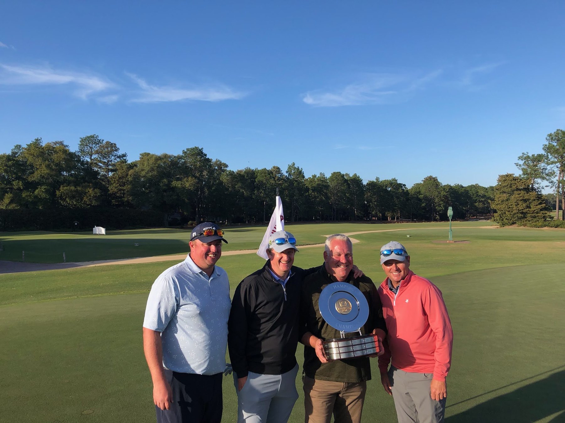 Jake Snyman with chapter colleagues and a golf trophy